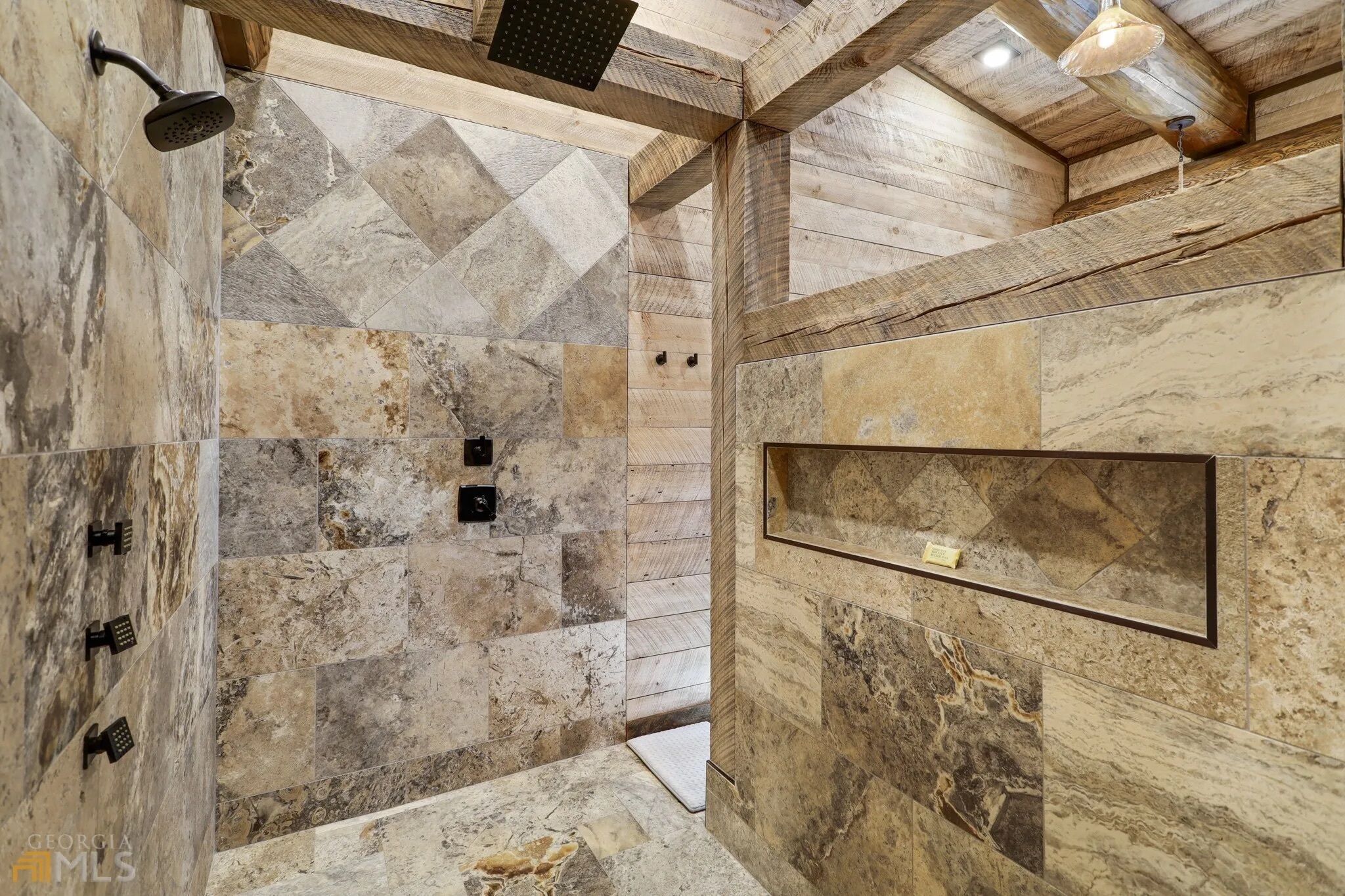 A shower area with a wooden ceiling and marble tiles.