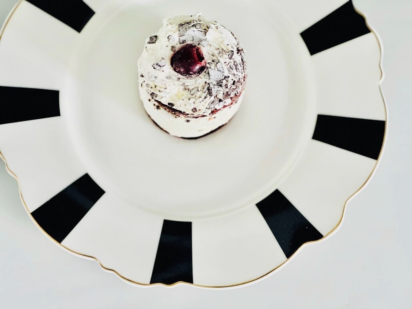 A dessert on a white plate with black accents.