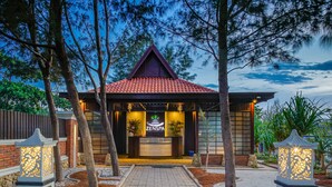 A spa with a red-tiled roof, wooden facade, and a pathway leading to the entrance. - Sekuro Village Beach Resort (Mlonggo)