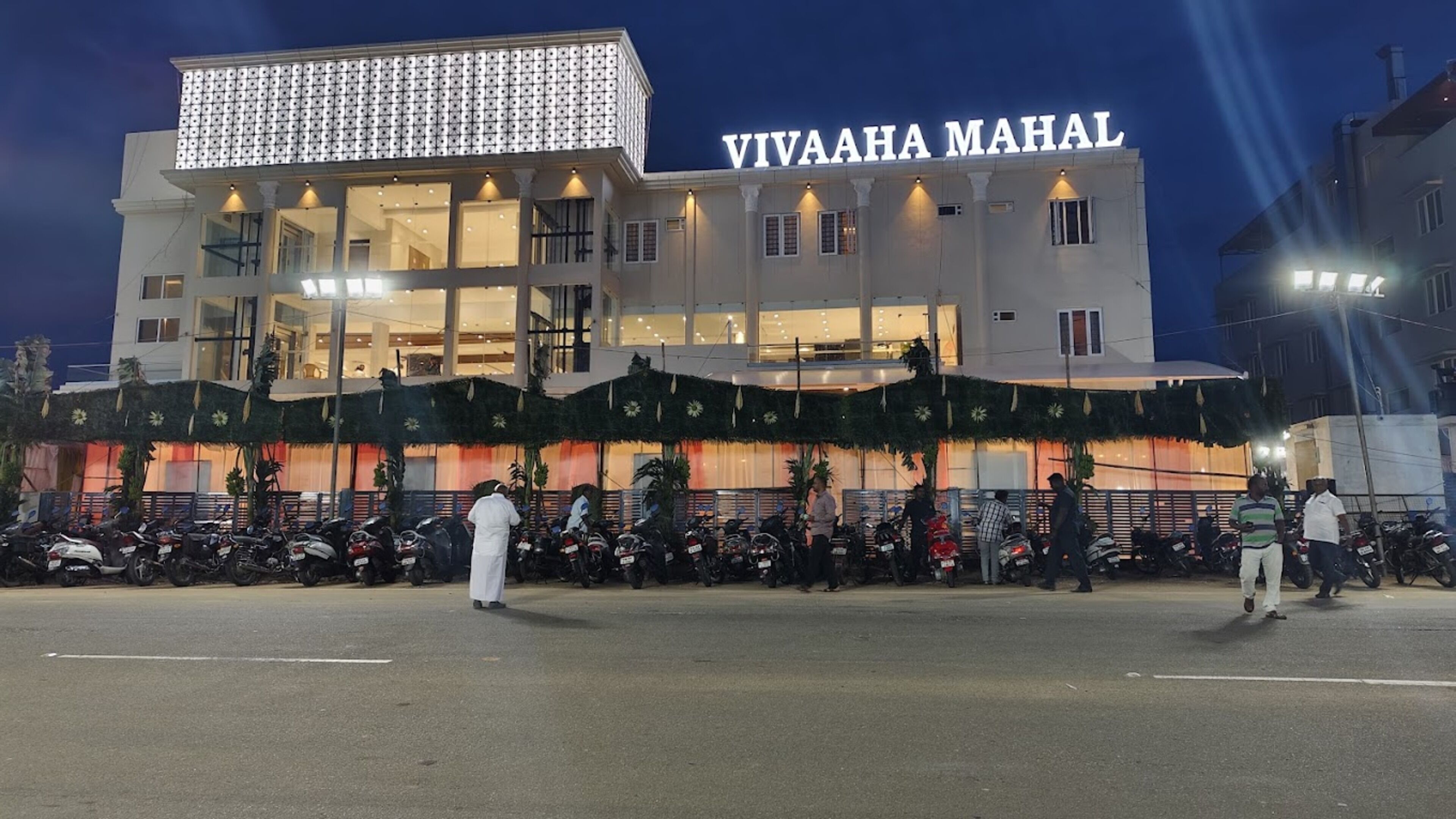 A building with a sign reading "VIVAHA MAHAL" at night.