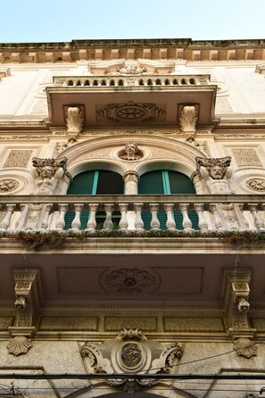 A building facade with ornate architectural details, including sculpted figures and decorative moldings. - Sisuites (Bari)