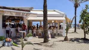 Ein Restaurant direkt am Strand mit Außenbereich und Meerblick.