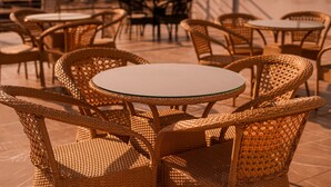 Wicker chairs and tables arranged outdoors, likely in a cafe or restaurant setting. - Hotel Northwind Mohali (Kharar)