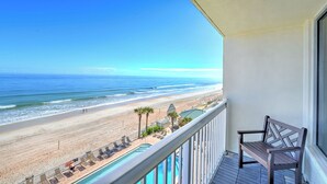 Uma varanda com vista para a praia e o oceano.