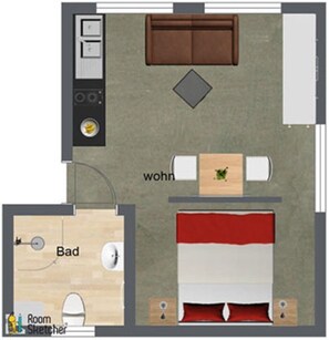 A room with a bed, a desk, a chair, a sofa, and a small bathroom.