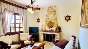 Un salon chaleureux avec une cheminée, des meubles en bois et des éléments décoratifs sur les murs.
