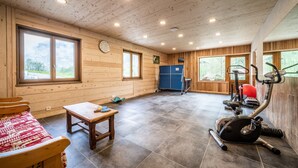 A wooden cabin with a gym, a table, and a bench. - Apartment 'Coeur De Charmy' with Mountain Views and Wellness Spa (Abondance)
