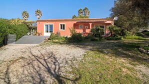 A single-story building with a red facade, a front door, and a small window. - Vacation Home "Arcadia T3" with Private Pool, 2 Terraces & Wi-Fi (São Bartolomeu de Messines)