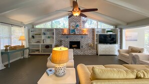 Cozy living room with a fireplace, TV, and comfortable seating.