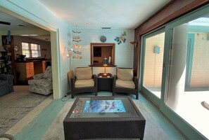 Relax in this inviting living room with a comfortable seating area, coffee table, and warm ambiance.