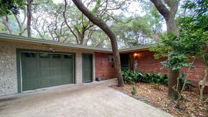 Set amidst mature trees, this home features a two-car garage and a charming attached structure.