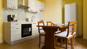 Cocina compacta con comedor, que incluye estufa, horno y muebles de cocina modernos.