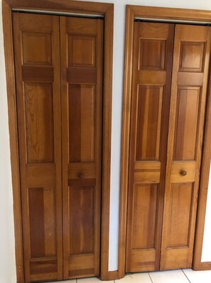 Two wooden doors with panel designs and handles.