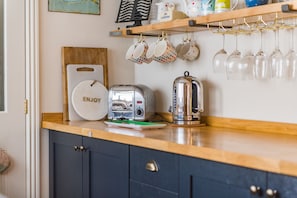 A kitchen counter with a toaster, a kettle, and a sign that says 'ENJOY'. - Star Cottage, Whitstable (Whitstable)