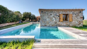 A stone building with a tiled roof next to a swimming pool. - Villa Stella - Four Bedroom Villa, Sleeps 8 (Lumio)