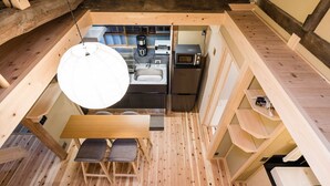 Une cuisine compacte équipée d’un évier, d’un four à micro-ondes et d’une machine à café.