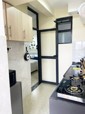 Fridge, microwave, electric kettle, cookware/dishes/utensils