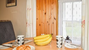 A breakfast table with croissants, bananas, and coffee mugs. - Skye is a magical, mystical and romantic island. (Braes)