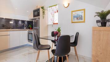Apartment (One Bedroom Apartment with Balcony an) | Private kitchen | Fridge, dining tables