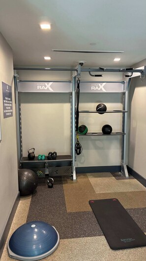 A gym with a pull-up bar, kettlebells, a medicine ball, and a mat. - Preston Douglas Single I Premium 1BR in Dallas (Dallas)