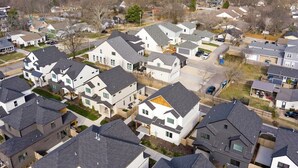 A residential area with modern houses, some with attached garages and others with detached garages.