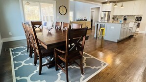 A spacious kitchen with wooden cabinets, stainless steel appliances, and pendant lighting. - Spacious Lake Norman Waterfront with hot tub, game room, kayaks & SUPs! (Mooresville)