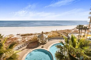 A beachfront hotel with a pool area, beach access, and a view of the ocean. - Always Beachin-Condo Ocean Views (Orange Beach)