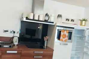 Enjoy cooking in this well-equipped kitchen with a stove, oven, kettle, and coffee maker.