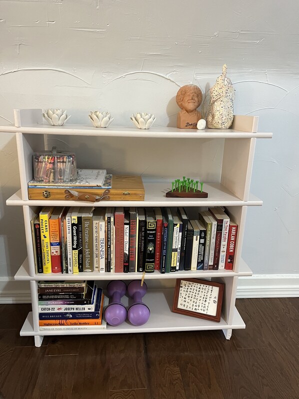 A bookshelf with various books, a small globe, and decorative items.