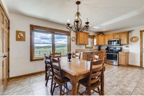 Enjoy meals at the large dining table surrounded by comfortable chairs.