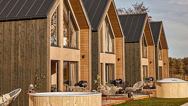 A row of wooden cabins with pitched roofs and large windows, each featuring outdoor seating and a barbecue grill. - 2 bedroom cozy home in Trzesacz (Trzesacz)