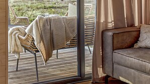 A cozy living area with a sofa and a chair by a large window. - 2 bedroom cozy home in Trzesacz (Trzesacz)