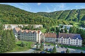 Situated in a lush valley, this hotel offers a scenic backdrop of forested hills.