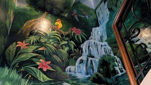 A mural of a waterfall and koi fish in a room with stairs. - Entire House in Safe & Peaceful, Gated, Golf Community with 2 Swimming Pools. (General Trias)