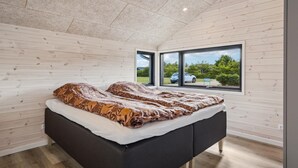 A bedroom with a bed, a window, and a view of the outside. - Nice home in Tarm with WiFi (Tarm)