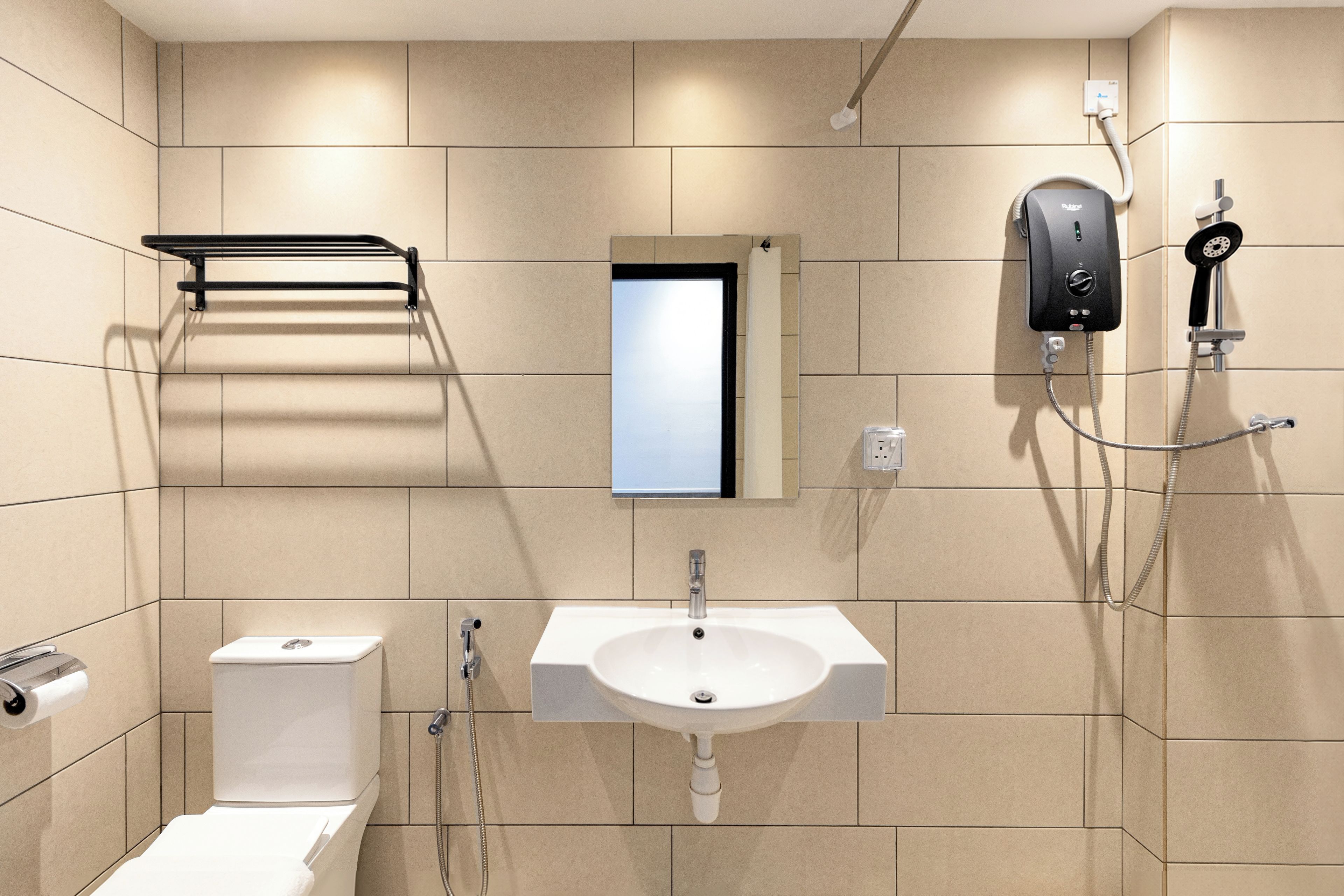 A modern bathroom with a toilet, sink, and shower.