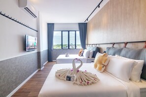 A hotel room with a large bed, a TV on the wall, and a view of the city through the window. - The Bagan Suite  (Butterworth)
