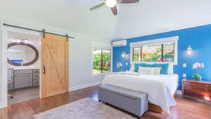 A bedroom with a bed, a bench, a ceiling fan, and a view of the outdoors. - Princeville Private 3 bed 2 bath w/AC (Princeville)