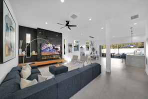 Relax in a spacious living area with a large sofa, flat-screen TV, and dining space.