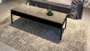 A living room with a grey sofa, orange cushions, a coffee table, and a patterned wallpaper. - Le Mathiez (Dijon)