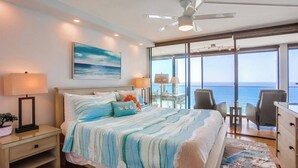A bedroom with a bed, bedside tables, a desk, and a view of the ocean. - 11th fl. Oceanfront view plus parking and pool (San Diego)