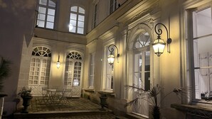 A courtyard with stone flooring, white-framed windows, and outdoor seating. - Apartment Bossoreil 110m2 - Hyper center Angers (Angers)