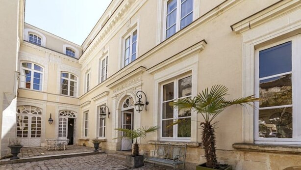 A courtyard with cobblestone paving, a bench, and potted plants. - Apartment Bossoreil 110m2 - Hyper center Angers (Angers)
