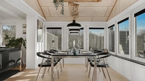 A dining area with a long table, black chairs, and a hanging light fixture. - Lovely home in Hurup Thy with sauna (Hurup Thy)