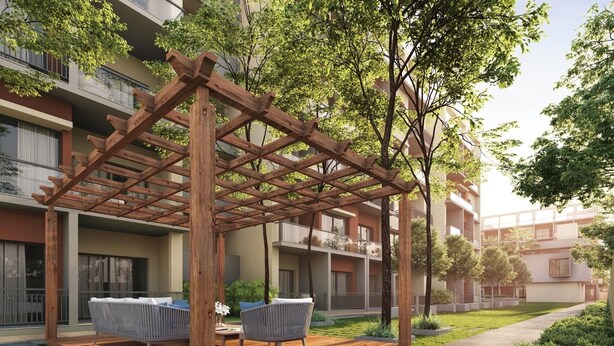 A wooden pergola with seating, surrounded by greenery and a modern building in the background. - Aminah’s Space - Jobz Luxury Rental (Bijilo)