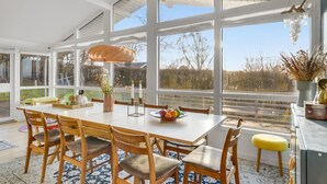 A bright dining area with a large table, wooden chairs, and a modern pendant light. - Amazing home in Vejby with WiFi (Vejby)