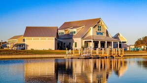 A waterfront property with a large house and a dock extending into the water. - Family Friendly House - Resort Style Amenities & Baby Gear (Beaufort)