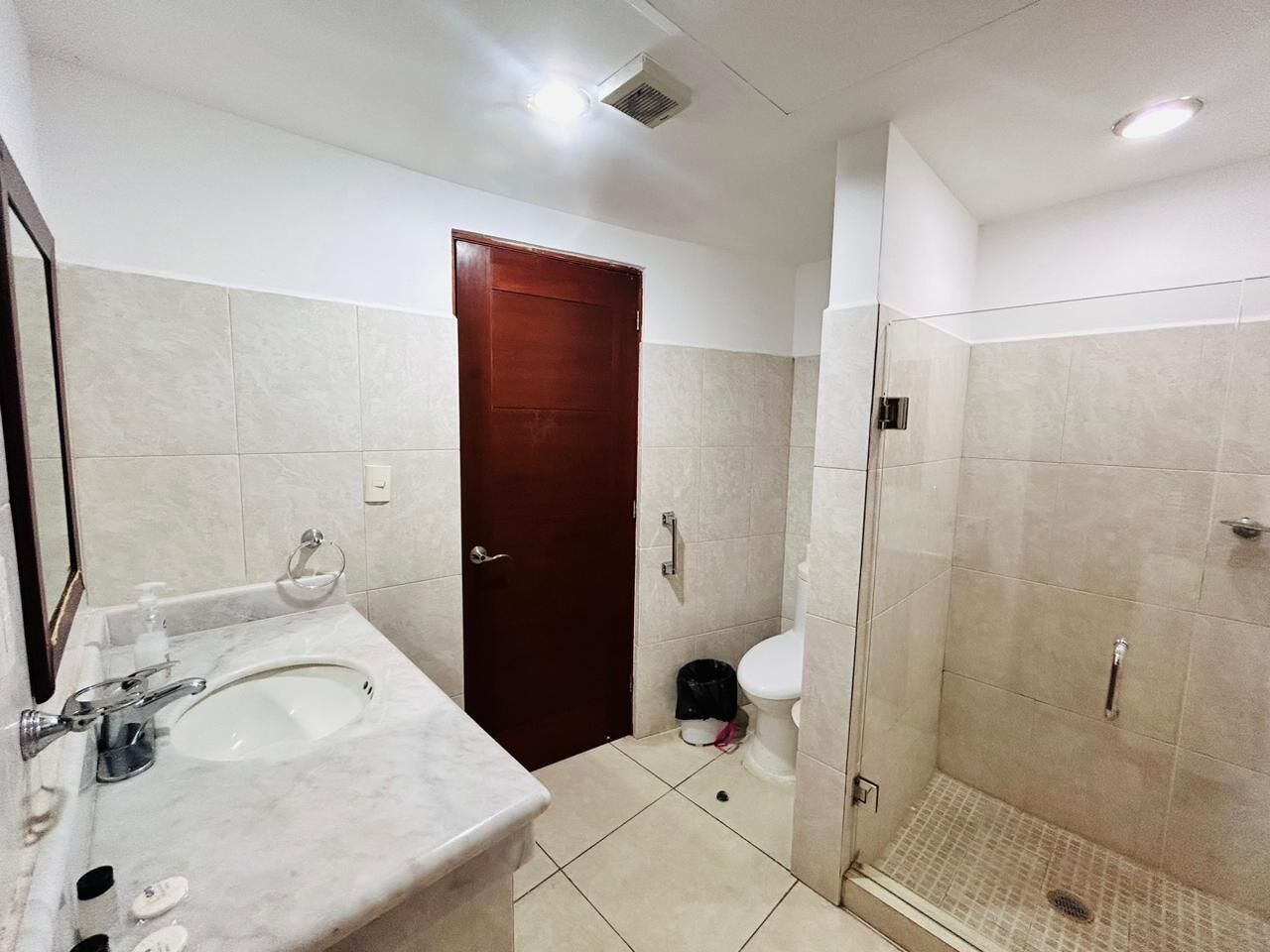 A bathroom with a sink, toilet, and shower.