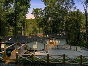Relax on the covered deck or unwind in the guest house, accessible via a staircase.