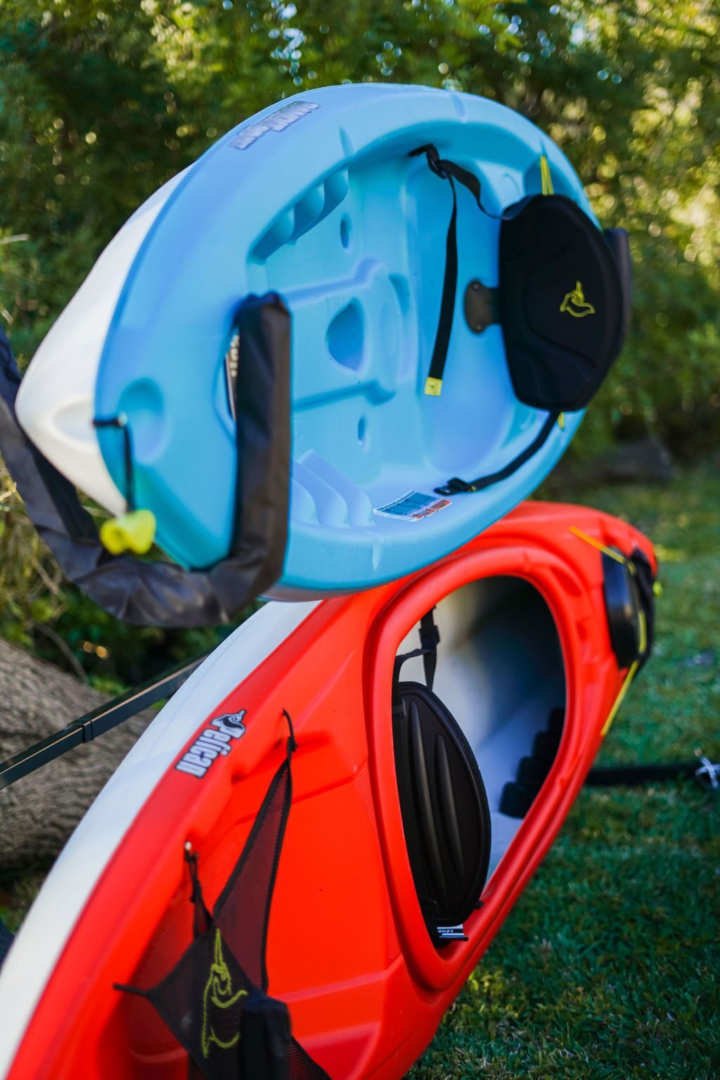 A red kayak with a blue top hatch and a black helmet.